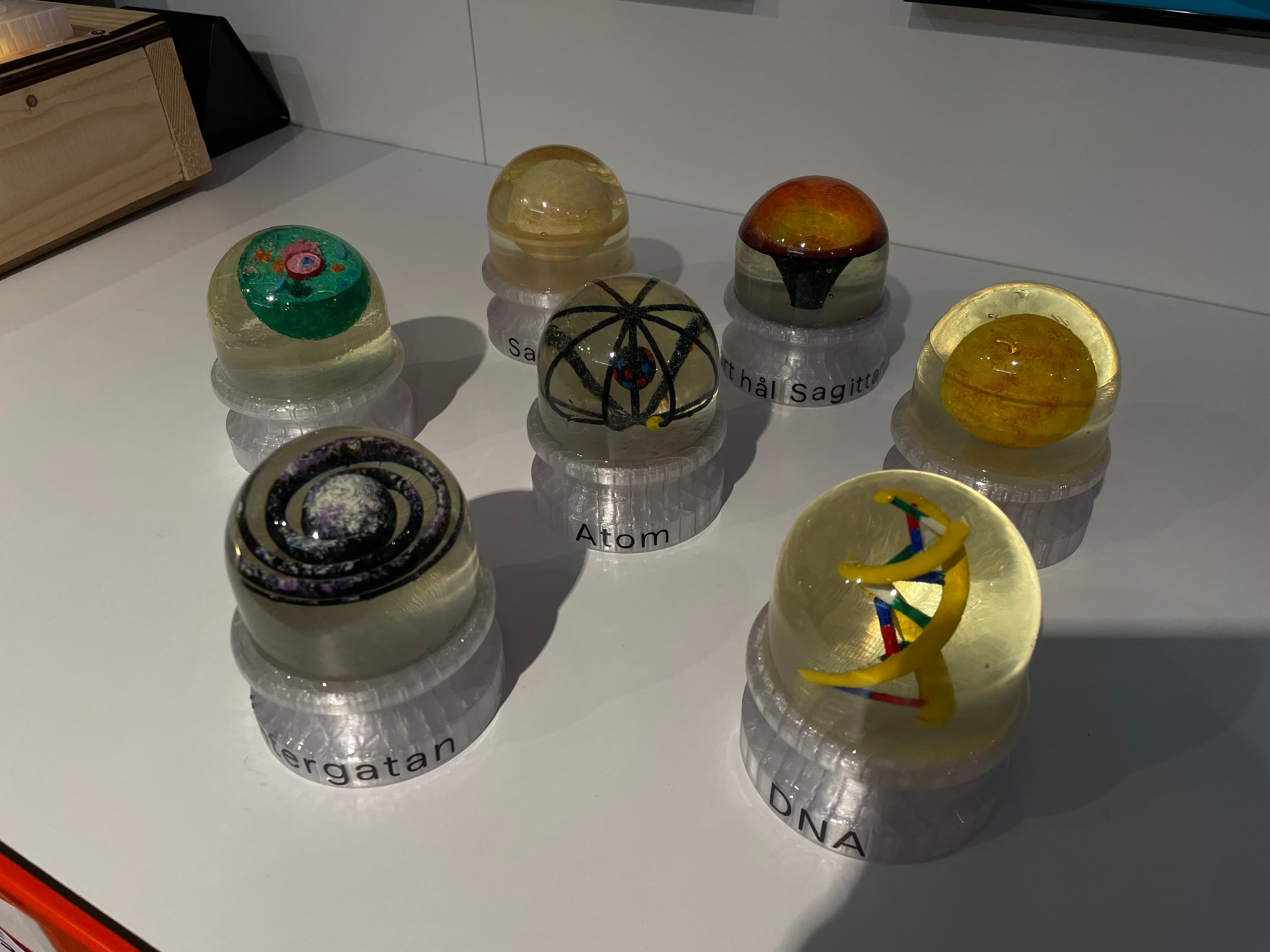 Small 3D-printed models used in the installation, each representing a different object on the scale of size, from DNA to a black hole.